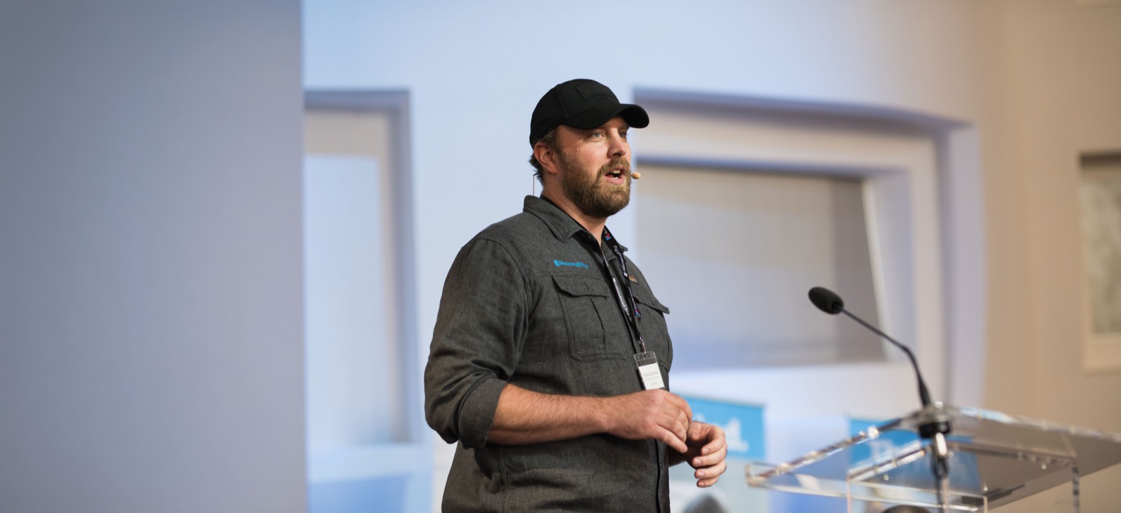 A Housecall Pro speaker presenting on stage at a regional-hub Trades Thursday event