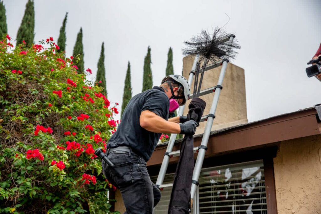 Chimney cleaning pro climbing down ladder