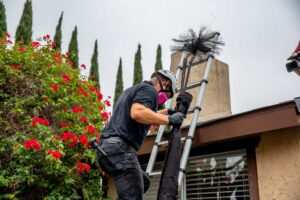Chimney cleaning pro climbing down ladder