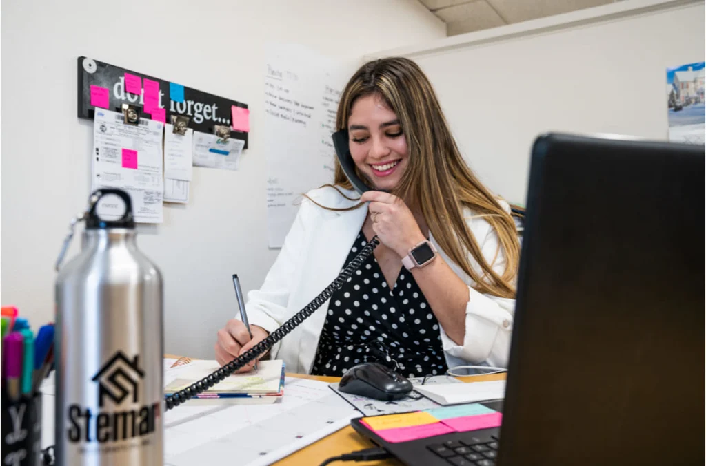 - Housecall Pro Woman on phone in office