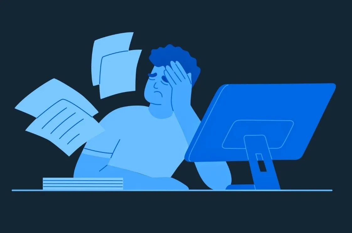 - Housecall Pro Man at desk looks frustrated with hand on head