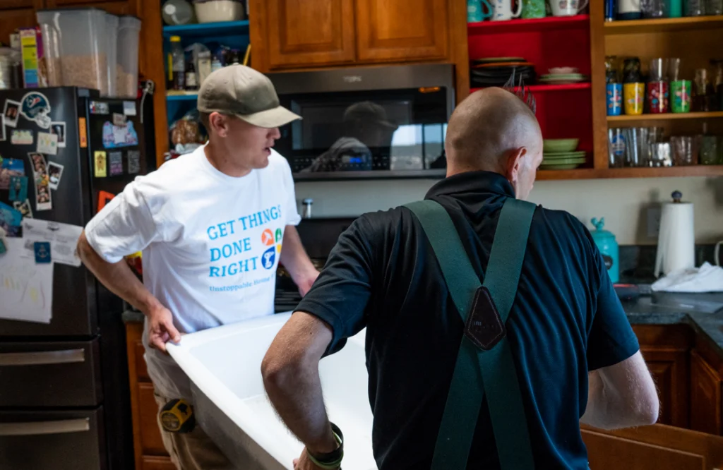 - Housecall Pro Two handyman pros carrying kitchen sink