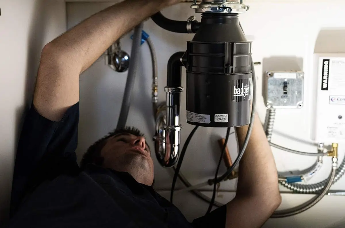 - Housecall Pro Plumber fixes pipe under kitchen sink