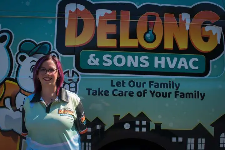 - Housecall Pro Amber Delong in front of Delong work van