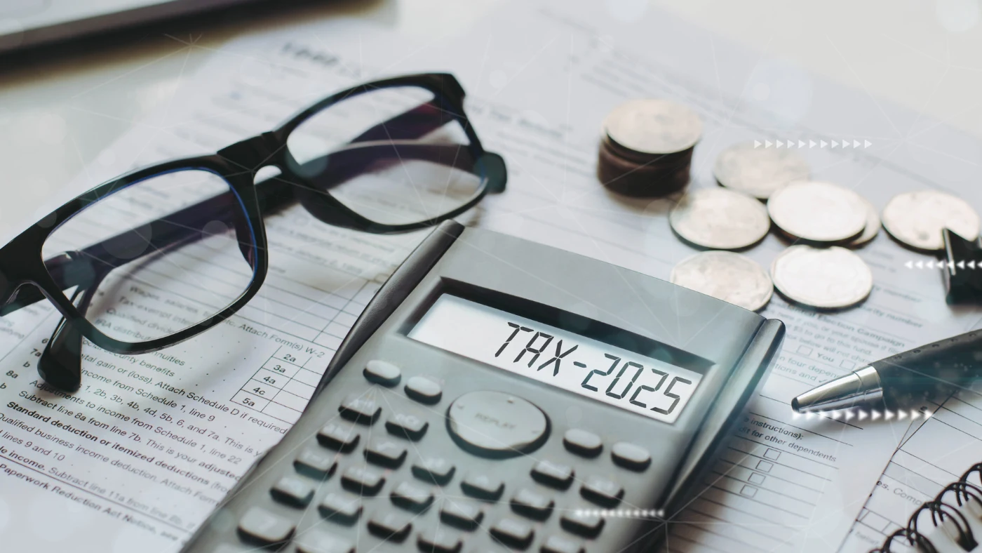 - Housecall Pro calculating new 2025 tax changes with a calculator