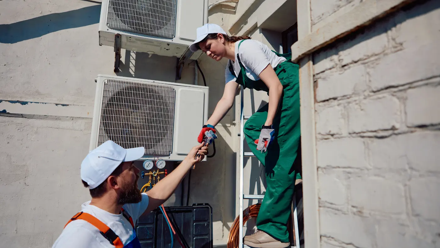 hvac technicians helping each other