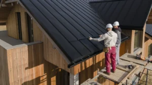 Roofing professionals installing panels on a modern house roof representing average roofer salary insights.