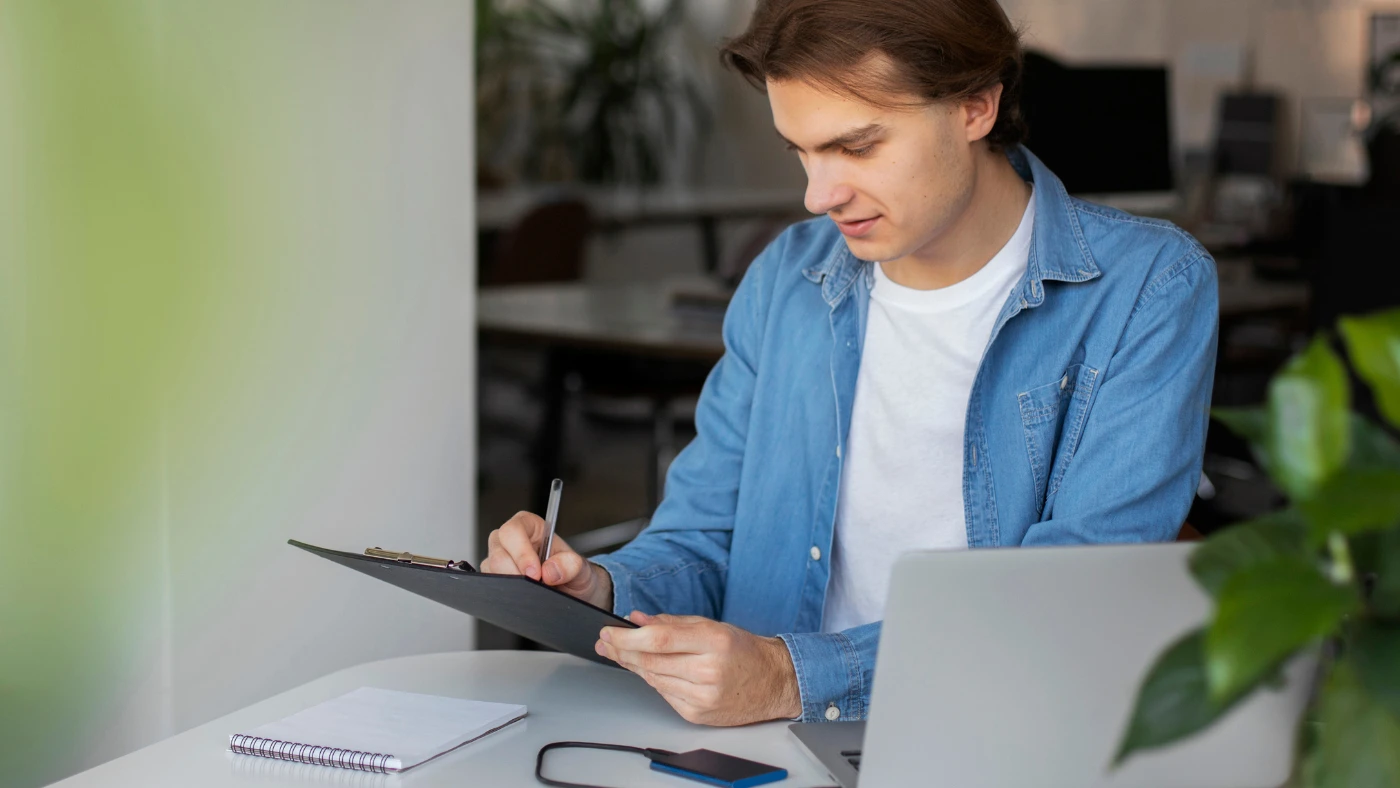 Handyman writing an invoice and recording service details for a completed job.