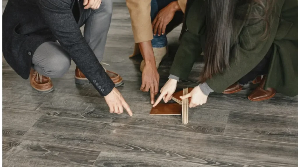 People comparing flooring material samples.