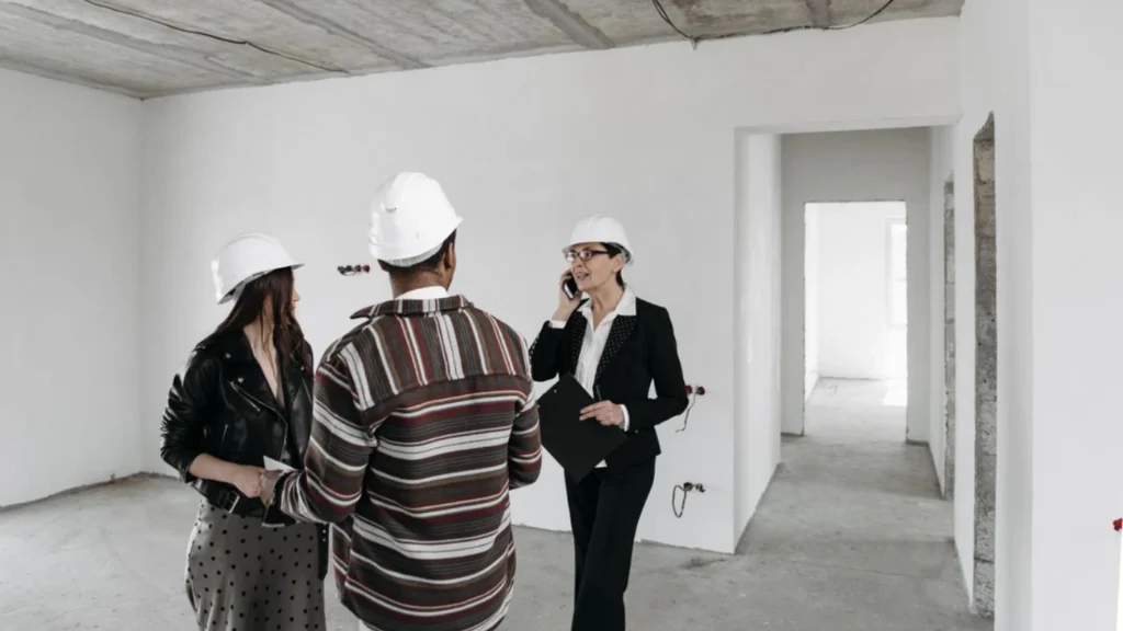 Flooring professional explaining installation costs, project scope, and pricing details to customers during a home consultation.