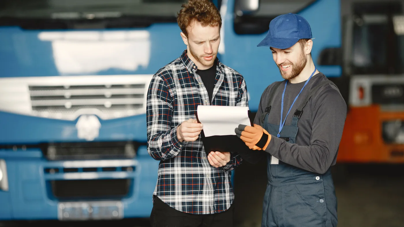 Two men in discussion over invoice documents